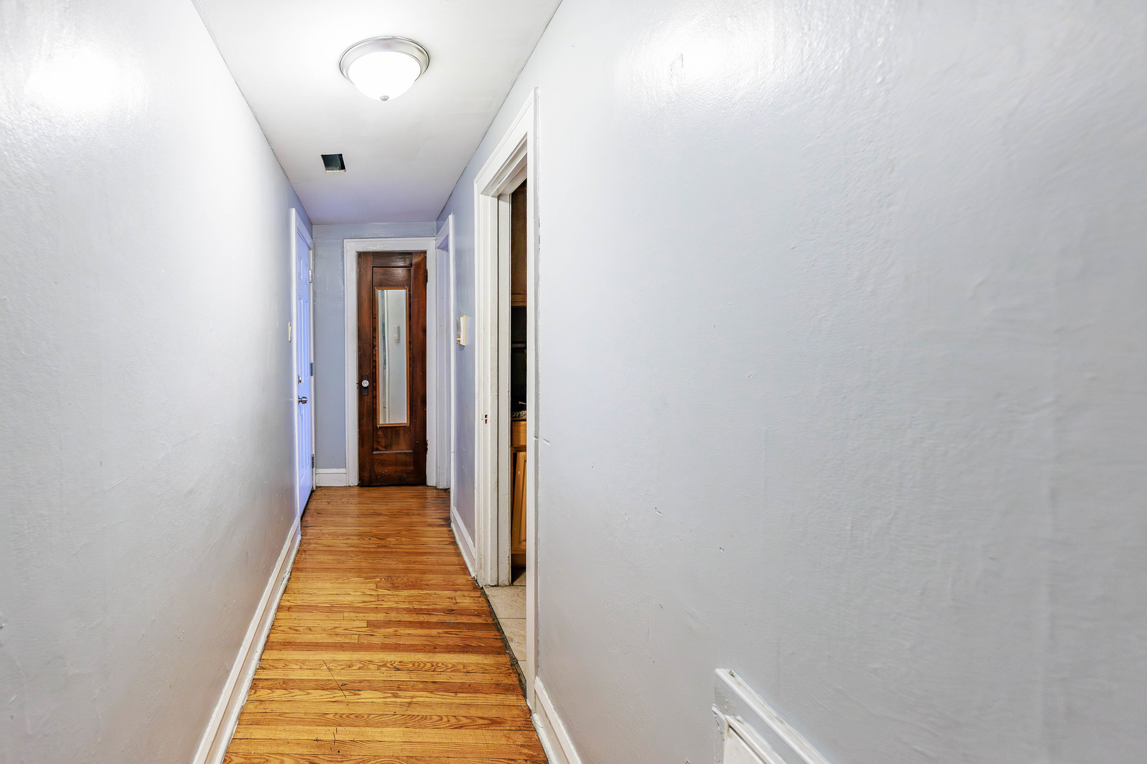 1513 West 87th Street Chicago, IL 60620 - Photo 23 of 28 a view of a hallway with wooden floor