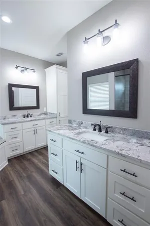 a room with a flat screen tv on the dresser