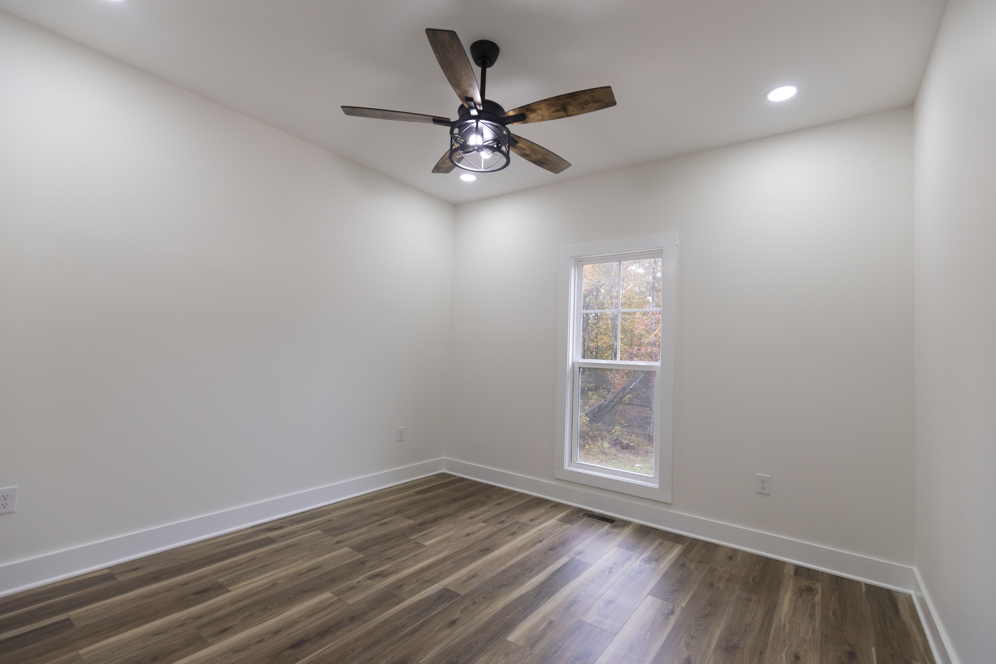 371 West Meadow Creek Road Monterey, TN 38574 - Photo 28 of 32 an empty room with wooden floor fan and windows