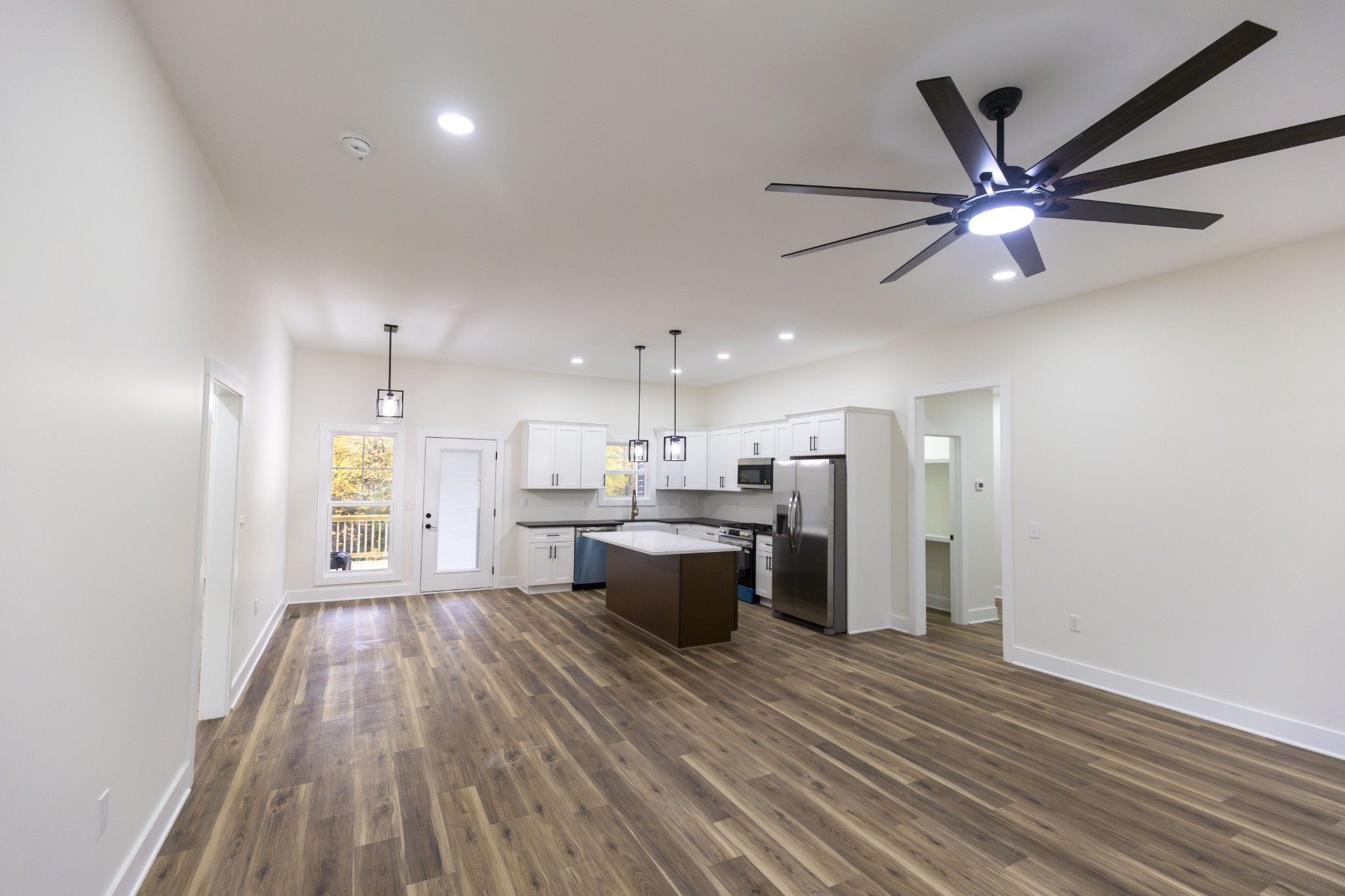 371 West Meadow Creek Road Monterey, TN 38574 - Photo 10 of 32 a view of a kitchen with kitchen island wooden floor center island and stainless steel appliances