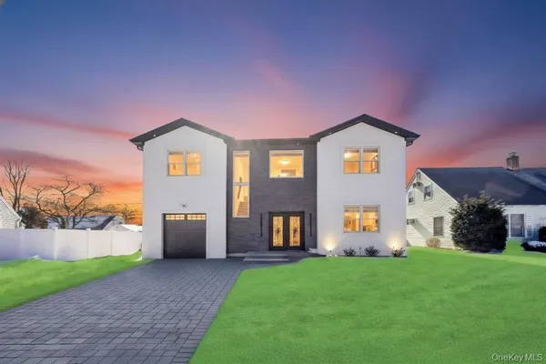 a front view of a house with a yard and garage