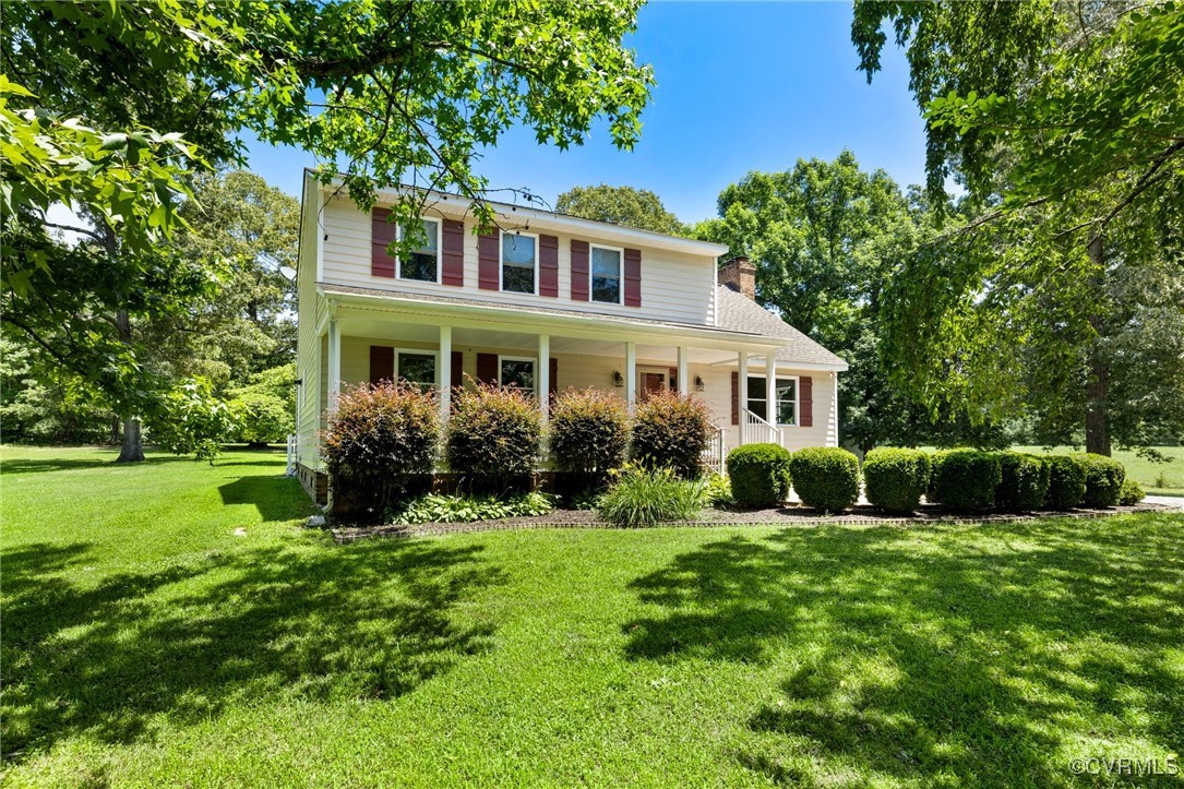 a view of a house with a yard and potted plants