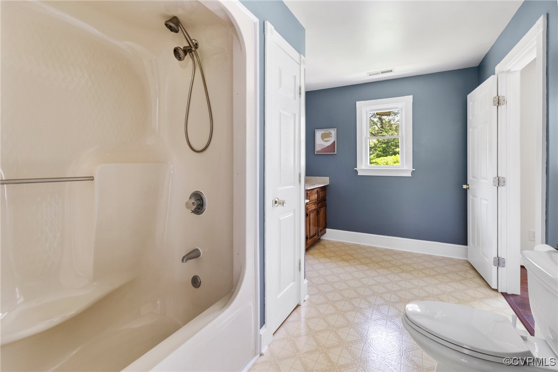 14398 Mountain Road Ashland, VA 23005 - Photo 23 of 36 a bathroom with a granite countertop bathtub shower and toilet