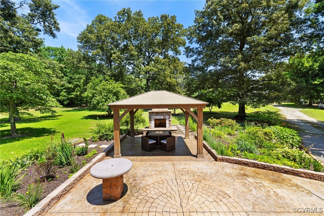 14398 Mountain Road Ashland, VA 23005 - Photo 28 of 36 a view of a table and chairs under an umbrella