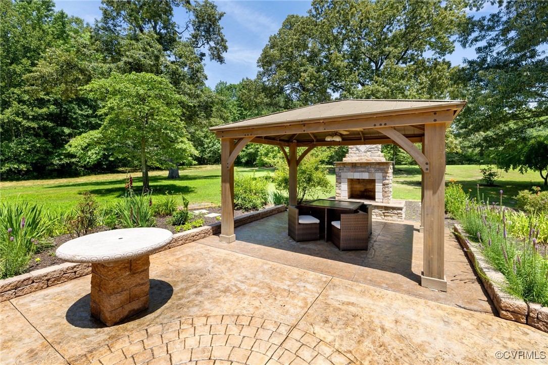 14398 Mountain Road Ashland, VA 23005 - Photo 29 of 36 a view of a patio with a table chairs and a backyard