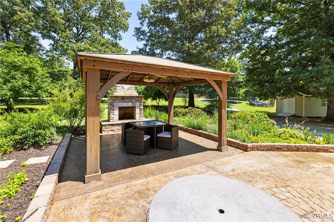 14398 Mountain Road Ashland, VA 23005 - Photo 30 of 36 a view of a patio with a table chairs potted plants and a large tree