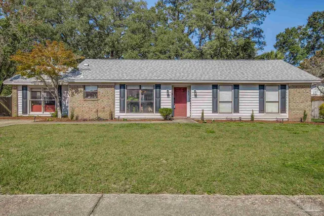a front view of house with yard and green space