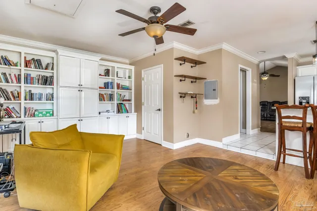 a living room with furniture cabinets and a rug