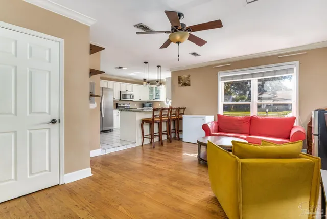 a living room with furniture and kitchen view