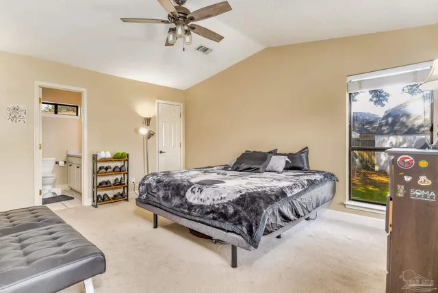 a bedroom with a bed a couch and dresser