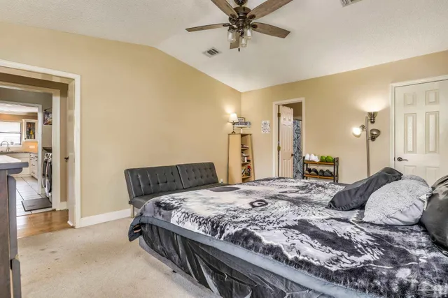 en empty room with windows and fan