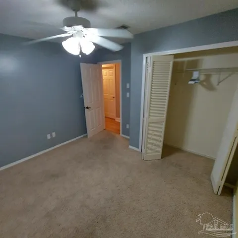 a white toilet sitting next to a shower curtain