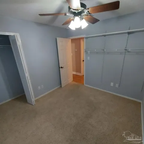 a bedroom with a bed and a mirror