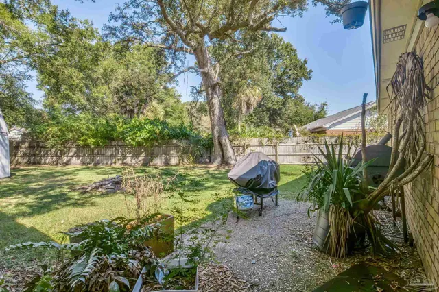 a backyard of a house with yard table and chairs