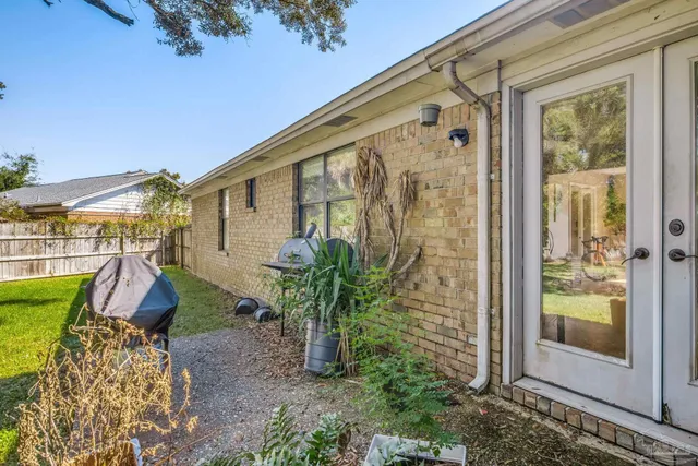 a view of a yard with wooden fence