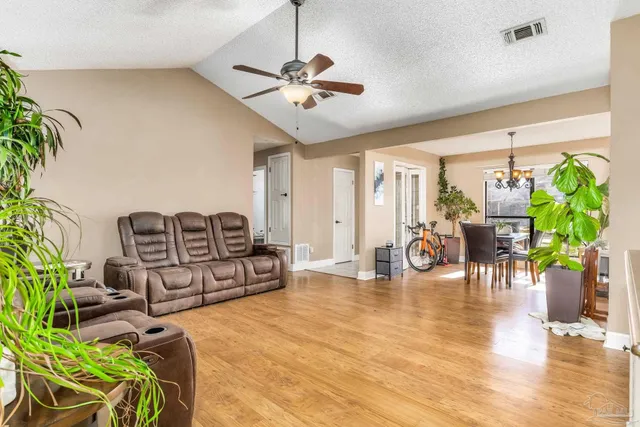 a living room with furniture and a chandelier
