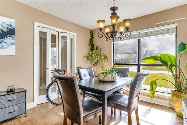 a dining room with furniture and chandelier
