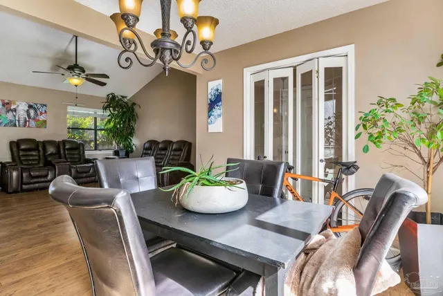 a living room with fireplace furniture and a potted plant