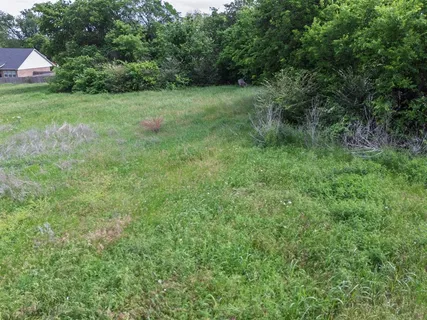 a view of green field with wooden fence