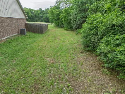 a backyard of a house with lots of green space