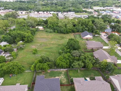 an aerial view of a house with a garden and lake view
