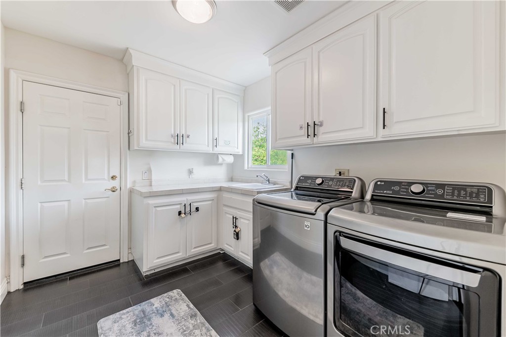 20491 Carancho Road Temecula, CA 92590 - Photo 15 of 64 a kitchen with granite countertop white cabinets and white appliances