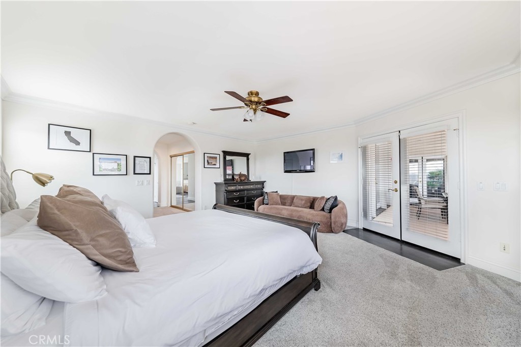 20491 Carancho Road Temecula, CA 92590 - Photo 22 of 64 a bedroom with a large bed and a chandelier