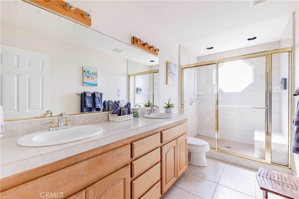 20491 Carancho Road Temecula, CA 92590 - Photo 31 of 64 a bathroom with a double vanity sink mirror and toilet
