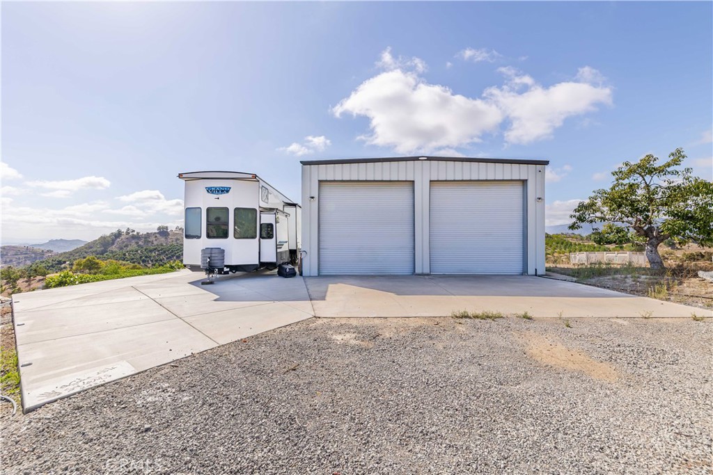 20491 Carancho Road Temecula, CA 92590 - Photo 52 of 64 a view of a house with backyard and porch