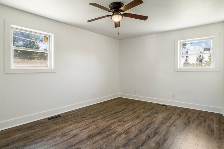 7640 Oak Grove Road Monroe, TN 38573 - Photo 12 of 31 a view of a big room with wooden floor and windows