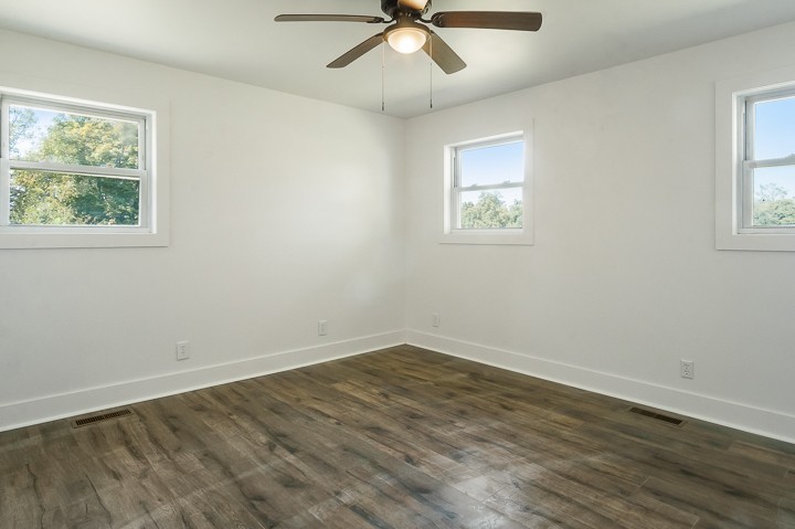 7640 Oak Grove Road Monroe, TN 38573 - Photo 15 of 31 a view of an empty room with wooden floor and a window