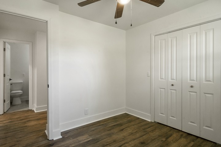 7640 Oak Grove Road Monroe, TN 38573 - Photo 19 of 31 an empty room with wooden floor cabinet and windows