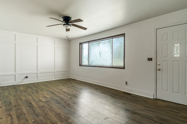 7640 Oak Grove Road Monroe, TN 38573 - Photo 3 of 31 a view of an empty room with wooden floor and a window