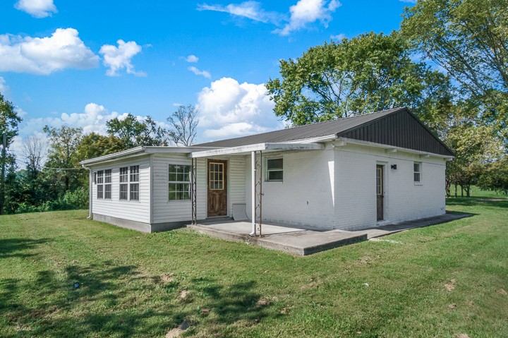 7640 Oak Grove Road Monroe, TN 38573 - Photo 24 of 31 a view of a house with yard and a garden