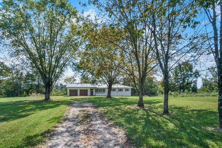 7640 Oak Grove Road Monroe, TN 38573 - Photo 25 of 31 a front view of a house with a yard