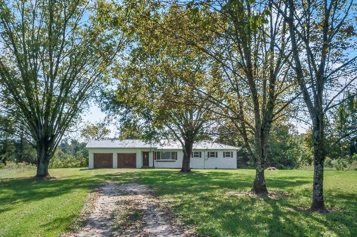 7640 Oak Grove Road Monroe, TN 38573 - Photo 26 of 31 a front view of a house with a garden