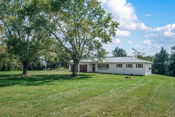 7640 Oak Grove Road Monroe, TN 38573 - Photo 28 of 31 a view of a house with a backyard