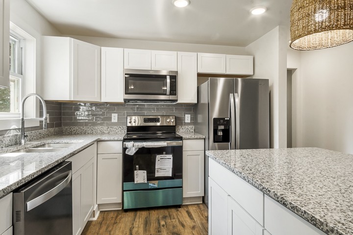 7640 Oak Grove Road Monroe, TN 38573 - Photo 6 of 31 a kitchen with kitchen island granite countertop a stove sink and refrigerator