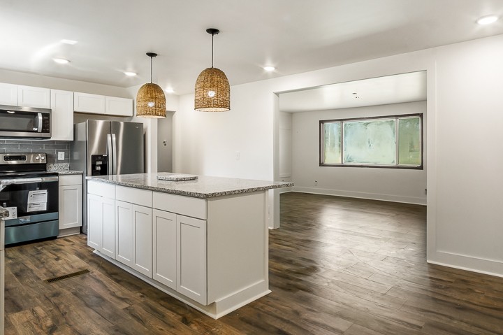 7640 Oak Grove Road Monroe, TN 38573 - Photo 7 of 31 a kitchen with stainless steel appliances granite countertop a stove a sink and a refrigerator