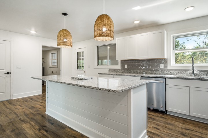 7640 Oak Grove Road Monroe, TN 38573 - Photo 8 of 31 a kitchen with granite countertop a sink a window stainless steel appliances and white cabinets