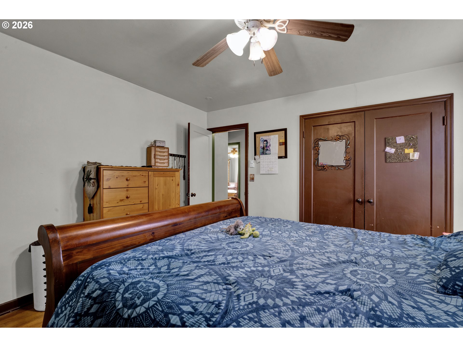 780 Cherry Avenue Eugene, OR 97404 - Photo 16 of 29 a bedroom with a bed and a chandelier