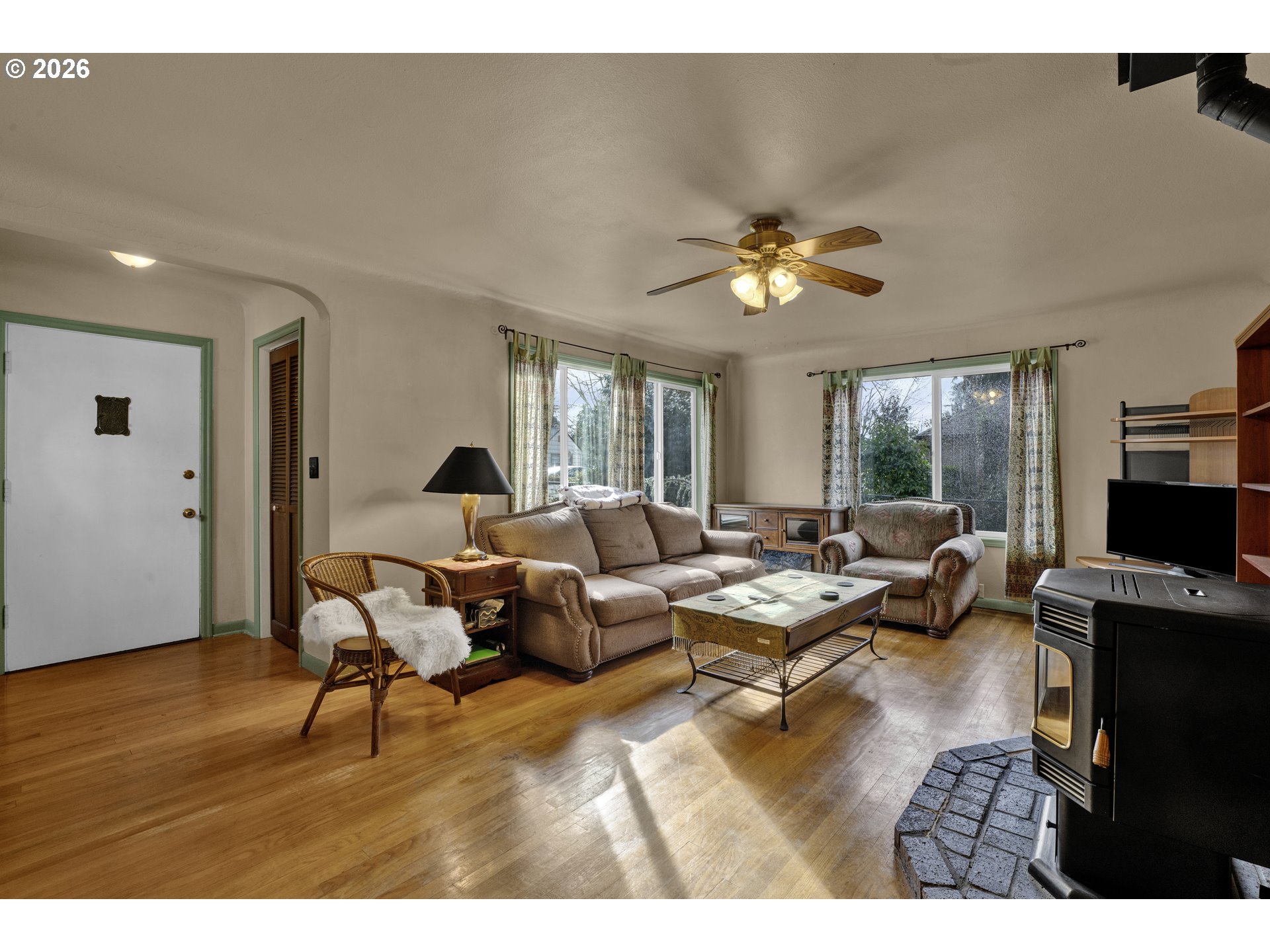 780 Cherry Avenue Eugene, OR 97404 - Photo 7 of 29 a living room with furniture flat screen tv and a large window