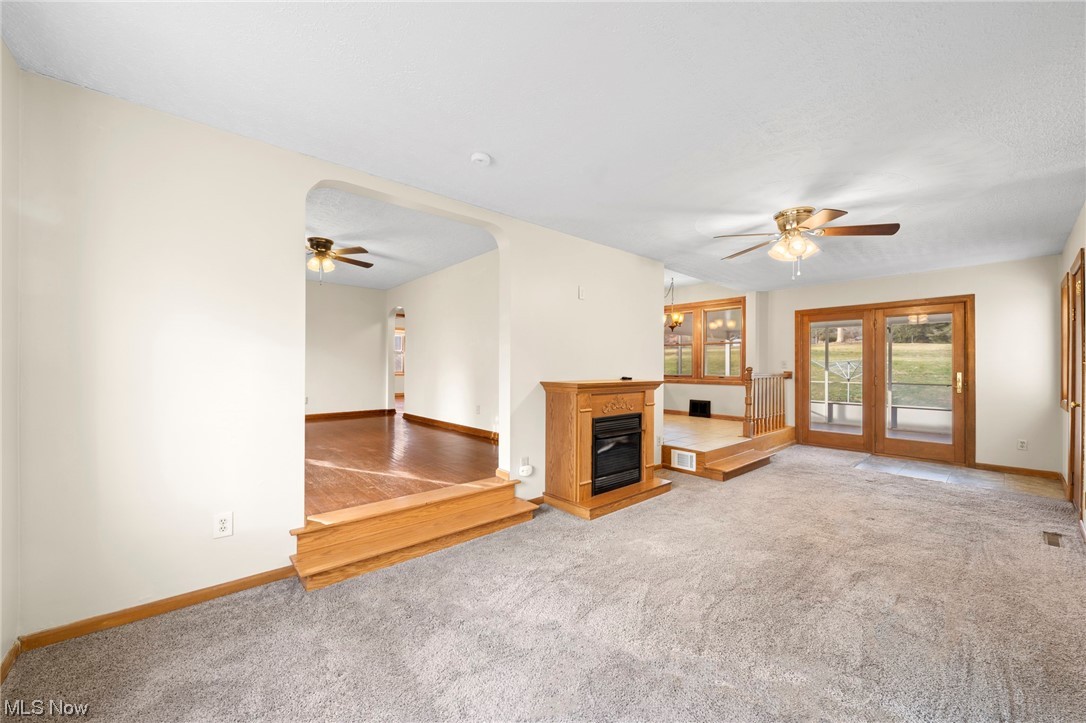 227 South Messner Road New Franklin, OH 44319 - Photo 16 of 44 Unfurnished living room featuring ceiling fan and light carpet