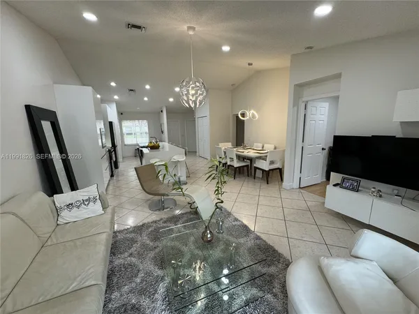 a living room with furniture and a flat screen tv