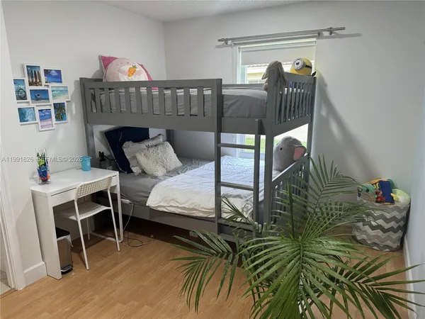 a bedroom with a bed a table and a closet