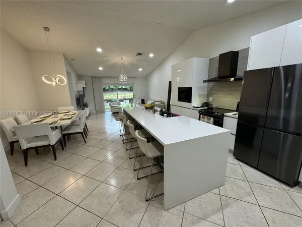 a kitchen with a sink a counter top space and stainless steel appliances
