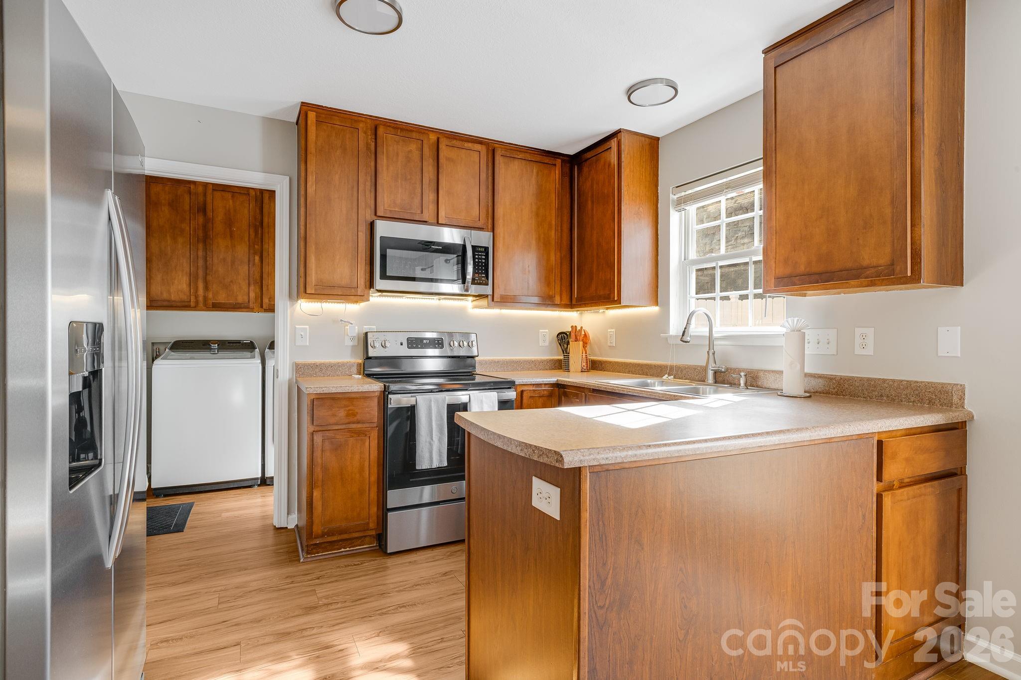 49 Farington Circle Fletcher, NC 28732 - Photo 13 of 32 a kitchen with stainless steel appliances granite countertop a sink stove microwave and refrigerator