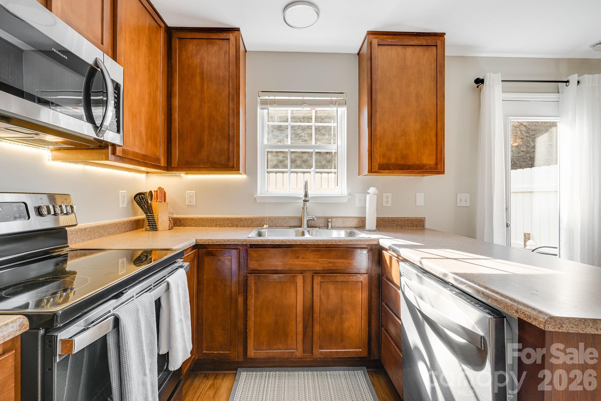 49 Farington Circle Fletcher, NC 28732 - Photo 14 of 32 a kitchen with stainless steel appliances granite countertop a sink stove and cabinets