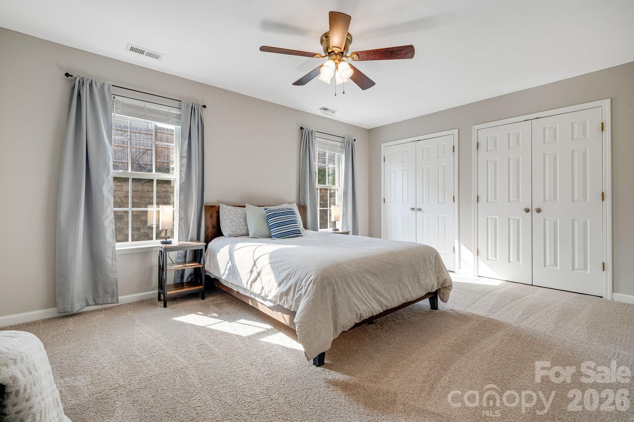 49 Farington Circle Fletcher, NC 28732 - Photo 18 of 32 a bedroom with a bed chandelier and a window