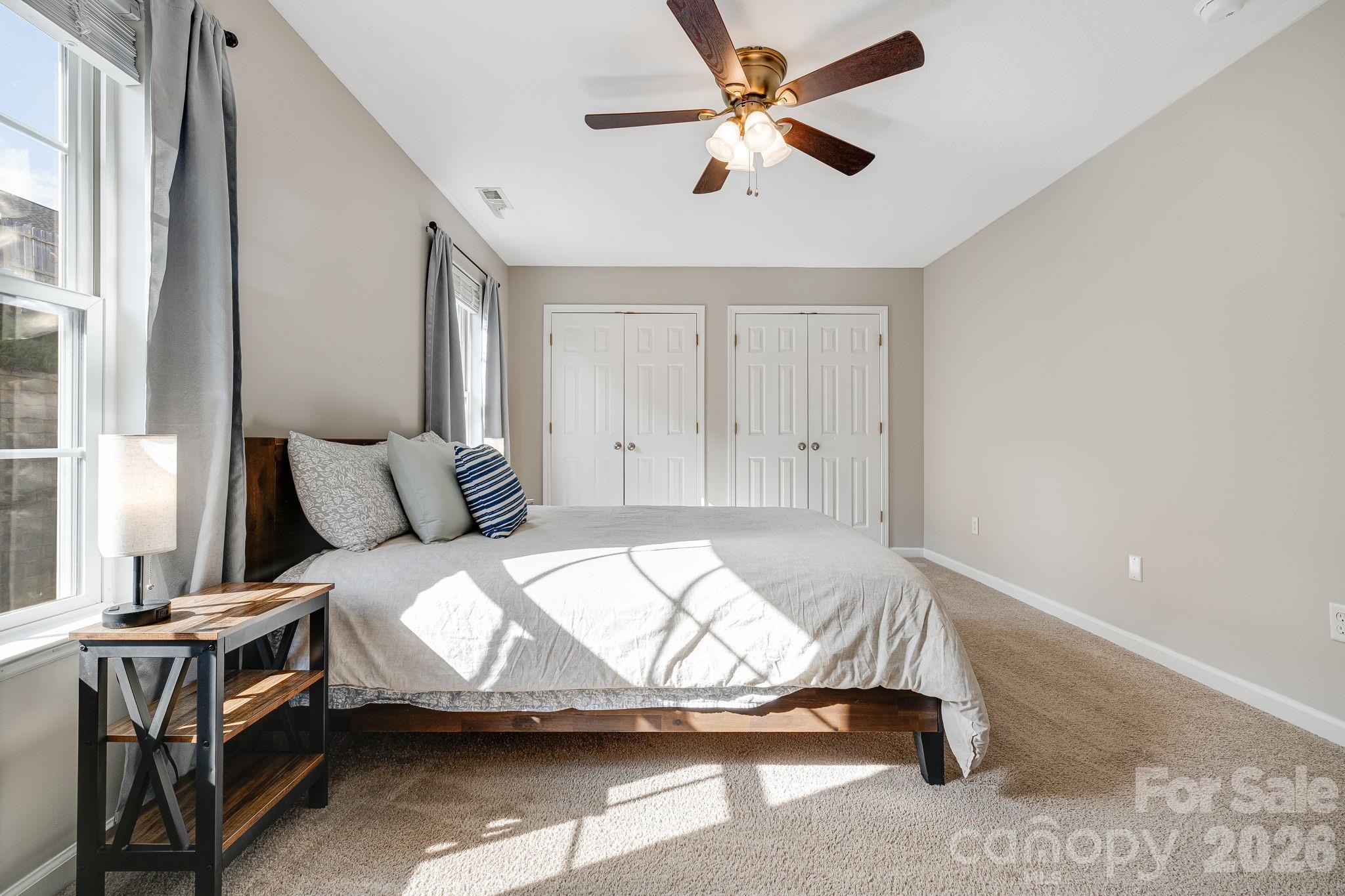 49 Farington Circle Fletcher, NC 28732 - Photo 19 of 32 a bedroom with a bed and a chandelier